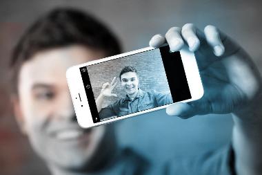 Image of young man taking a selfie