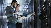 Image of two work colleagues looking at a network server