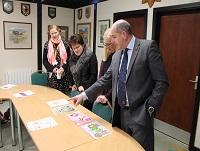 Image of judges looking at poster designs