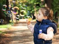 Image of a child blowing bubbles Image of a child blowing bubbles