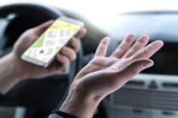 Image of man with phone in hand looking at map