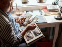 Image of a father and son looking at old photographs