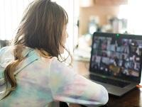 Image of a young person at a laptop