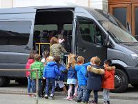 Image of children getting into a minibus