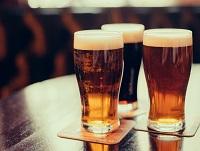 Image of three pints of beer on a wooden table