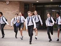 Image of secondary school pupils in uniform running