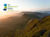 Image of Powys landscape and Growing Mid Wales logo