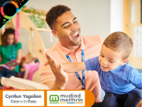 Image of a male early years staff member with a young child