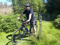 Photo of man riding e-bike in countryside