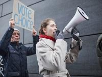 A woman using a megaphone to get her point across