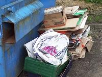 Image of commercial waste left at a community recycling site