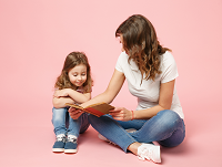Image of a woman reading with a young girl