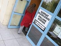 Image of a person walking into a polling station