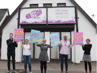 Image of people launching a campaign outside a building