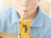 Image of a child drinking juice from a carton