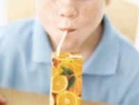 Image of a child drinking juice from a carton