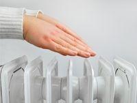 Image of someone holding their hands above a radiator
