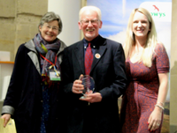 Image of Representatives from PAVO are pictured their award and with the High Sheriff of Powys, Tom Jones OBE