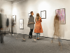 People looking at paintings at an art gallery