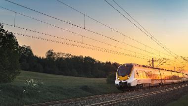 A train travelling through Powys at sunset
