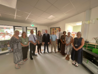 Picture of Jeremy Miles MS, Minister for Education and the Welsh Language with representatives from Powys County Council, Ysgol Gymraeg Dyffryn y Glowyr and early years setting staff as part of his visit to the purpose-built early years setting f