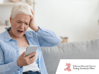 Image of a frustrated woman looking at her phone
