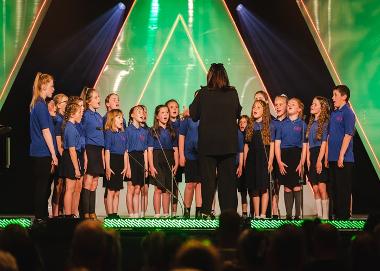 A group of schoolchildren competing on stage at the Urdd Eisteddfod