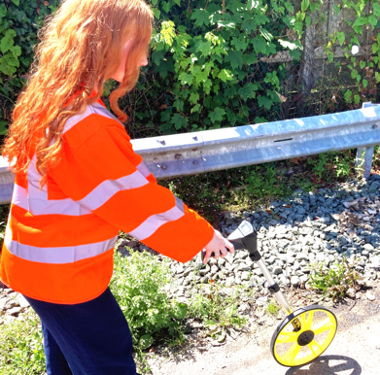 Photo of Joni measuring a road