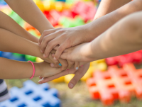 Image of people putting their hands together