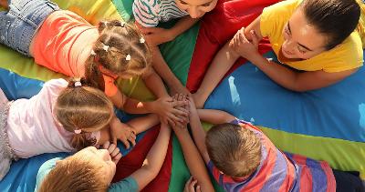 Children resting hands on top of each others hands