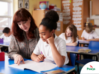 Image of a teacher helping a pupil in a classroom