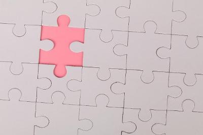 Pink puzzle pieces with one piece a different colour