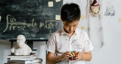 A child playing with a Rubiks Cube