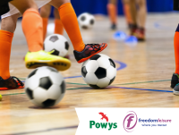 Image of football being played in a sports hall