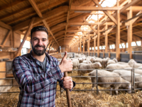 A young farmer making a thumbs up gesture