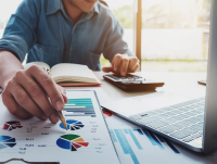 A person viewing budget charts and using a calculator