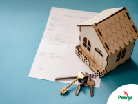 Image of a model house, keys and a piece of paper
