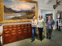 Left to right: Lorna Steel (Curator), Deborah Price and Rebecca Jones (Community, Culture and Digital Officers). Painting of Nant Gwyllt by Alfred East. 