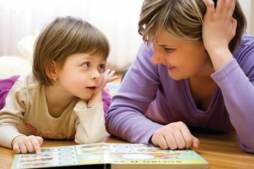 Image of a toddler reading with a woman Image of a toddler reading with a woman
