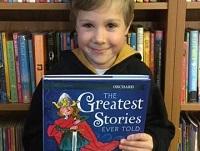 Image of a child with a book Image of a child with a book