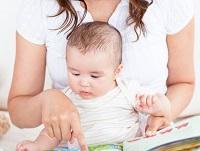Image of a baby looking at some books
