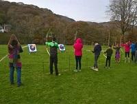 Image of people taking part in archery