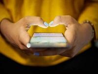 Image of a woman holding a mobile phone