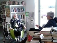 Image of two men talking to each other