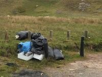 Image of fly-tipping on a road layby