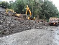 Image of diggers removing spoil after a landslide Image of diggers removing spoil after a landslide