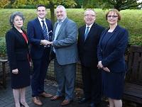 Image of a group of people watching Cllr James Evans receive an trading standards award Image of a group of people watching Cllr James Evans receive an trading standards award